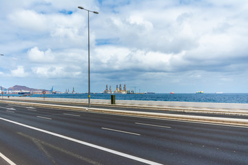 Isolated highway because COVID-19 quarantine with ocean background. Las Palmas de Gran Canaria, Spain