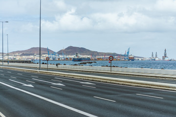 Isolated highway because COVID-19 quarantine with ocean background. Las Palmas de Gran Canaria, Spain