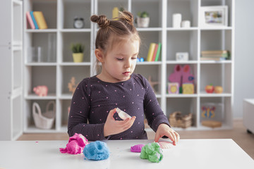 Little Happy Caucasian Girl Playing with Kinetic Sand at Home Early Education Preparing for School Development Children Game Stay at Home