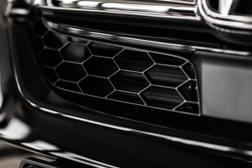 Grid of white sports car. The radiator grille. Metal texture. chrome grille of a big powerful....