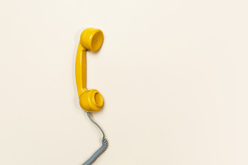 Old fashioned handset on beige background. Modern retro style.
