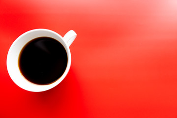 White cup of coffee on a bright red background. View from above. Menu, packaging design, poster, invitation card.
