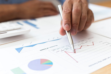 Businessmen analyze market data and calculate the cost of buying-selling products for a client's company, Professional marketing and financial accountants concept.