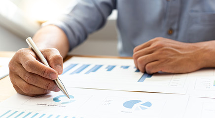 Businessmen analyze market data and calculate the cost of buying-selling products for a client's company, Professional marketing and financial accountants concept.