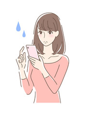 スマホを操作して不安な女性