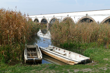 Scenic landscape with boats and the famous nine-holed bridge in Hortobagy, Hungary