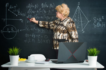 The teacher conducts an online lesson for students on laptop at home. Distance education concept.