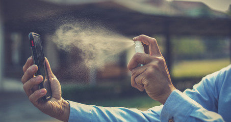 Young men use 70% alcohol spray to eliminate bacteria and viruses CORONA Or influenza COVID-19,...