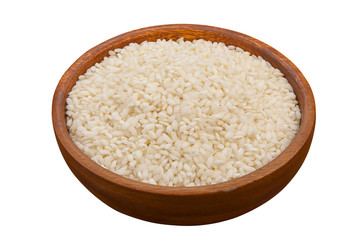 Fototapeta na wymiar Raw rice groats for risotto on plate