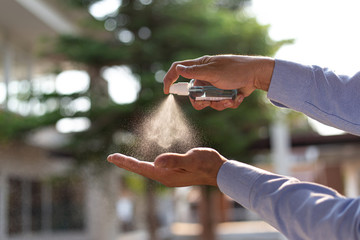 Young men use 70% alcohol spray to eliminate bacteria and viruses CORONA Or influenza COVID-19,...