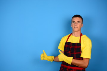 male apron housewife showing thumbs up in rubber gloves