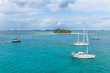 sailing yachts at anchor in the turquoise colored waters of the San Blas Islands, Kuna Yala, Panama