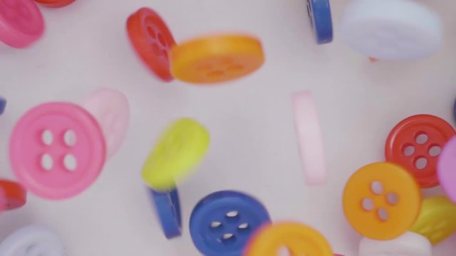 Buttons colorful couture falling. Many coloured buttons fall and run around. Color, fashion concept.