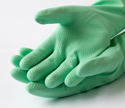 Hand In Green Latex Dishwashing Gloves On A White Background