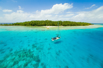 Sailing yachts anchoring in the shallow waters of suwarrow atoll, cook islands, polynesia, pacific ocean