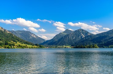 Schliersee, Bavaria, Bayern, Germany. Beautiful view on lake with alps mountains, blue sky with clouds. 