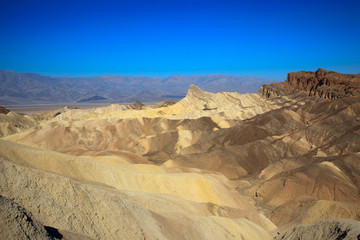 Fototapeta na wymiar California / USA - August 22, 2015: The landscape and rock formations around Zabriskie point near Death Valley National Park, California, USA