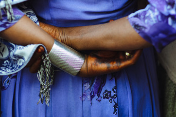 Close-up of a woman's hand tinted entirely with henna.Typical make-up of the Orthodox Christian women of Lalibela in Ethiopia. Background with blue suit.

