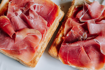 Toasts with serrano ham, traditional spanish breakfast