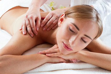 Obraz na płótnie Canvas Massage and body care. Spa body massage women hands treatment. Woman having massage in the spa salon for beautiful girl