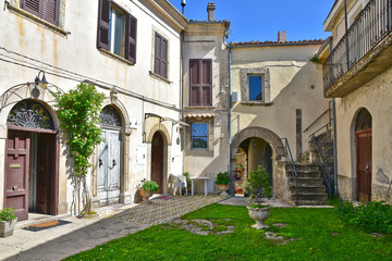 Fototapeta na wymiar Castel San Vincenzo, Italy, 07/12/2018. A narrow street between the houses of a village in the Molise region