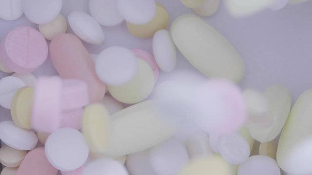 Medical pills falling. Treatment many coloured tablets, pills fall and run around. Medicine concept.