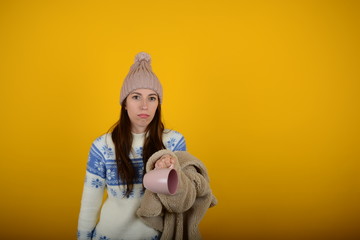 woman in a hat with a fur coat looks at the camera