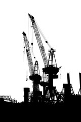 Hamburg, Germany. Cranes silhouetted in the harbor. Black and white.