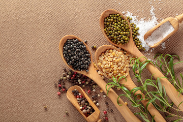 Various raw lentils with rosemary, salt and pepper.