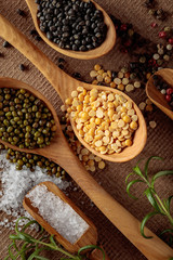 Various raw lentils with rosemary, salt and pepper.