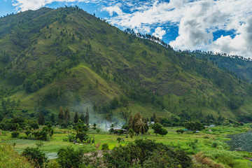 Vibrant farm lands next to amazing massive Lake Toba cliffs. One of the main Landmarks in Sumatra, Indonesia