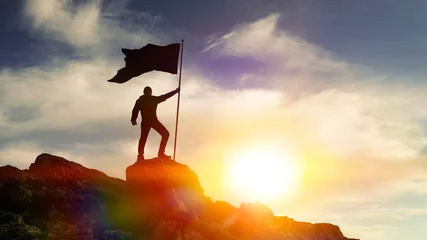 Fotobehang Man with flag on top of the mountain against the sky. Concept business ideas, success and achievement, winner leader. © gerasimov174
