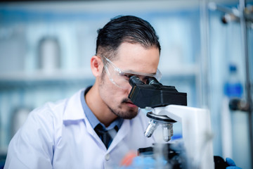 scientist working with microscope in laboratory, medical science research