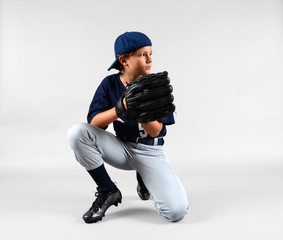 Male child baseball player kneeling with glove