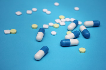 a lot of pills and pills on it on a blue background.