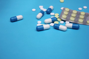 a lot of pills and pills on it on a blue background.
