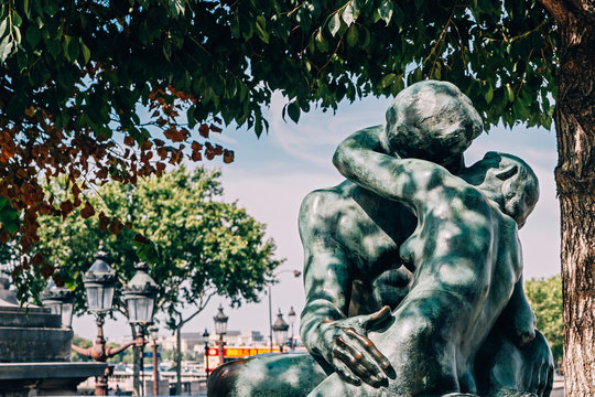 Tourist attraction "The Kiss" statue by Rodin in Tuileries Gardens and Place de la Concorde in Paris, France
