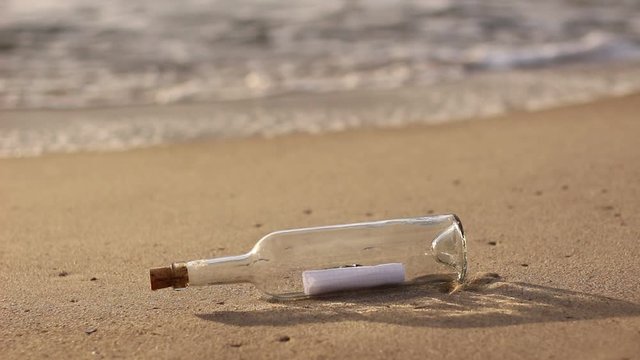message in a bottle by the ocean, A Letter or message in a bottle on the shore,cast out by ocean or sea