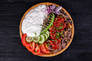 Fried meat with curd cream, baked pepper and fresh tomatoes and cucumbers with greens
