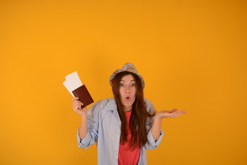 woman in a hat holding a passport and plane tickets holiday travel