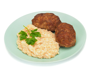 Homemade cutlets with wheat porridge on a plate and on white background.