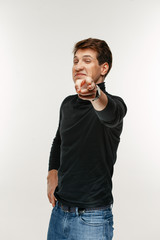 man pointing with finger at camera on white studio background