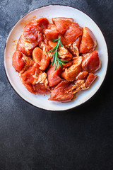 raw meat pork or beef in a plate on the table (preparing healthy food, marinade and spices paprika) menu concept background. top view. copy space for text