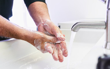 Man washing his Hands to prevent virus infection and clean dirty hands - corona covid-19 concept