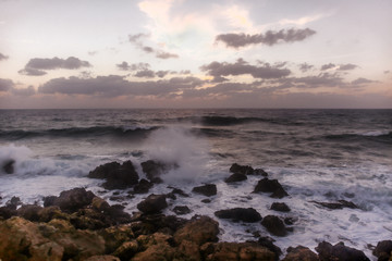 Stormy sunset on the Mediterranean Sea. Evening. Rocky coast. Sea Caves, Peyia, Cyprus