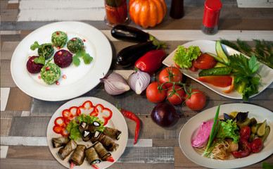 vegan dishes with fresh and salted vegetables on a wooden table. Healthy food. The view from the top