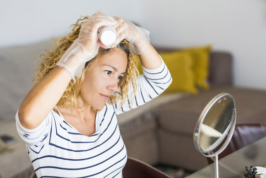 Home Made Hair Dye At Home For Beauty Young Caucasian Woman Looking At The Mirror - Stay At Home Concept For Coronavirus Emergency Worldwide Pandemic Contagion