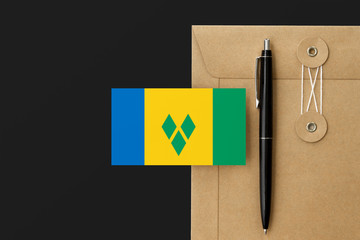 Saint Vincent And The Grenadines flag on craft envelope letter and black pen background. National...