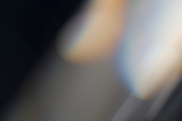 Lens flare and light leak haze texture on a black background.
