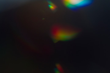 Lens flare and light leak haze texture on a black background.